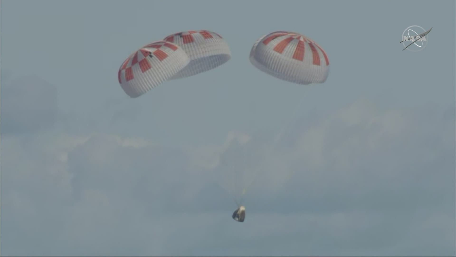 SpaceX's new crew capsule returned to Earth on Friday, ending its first test flight with an old-fashioned splashdown.