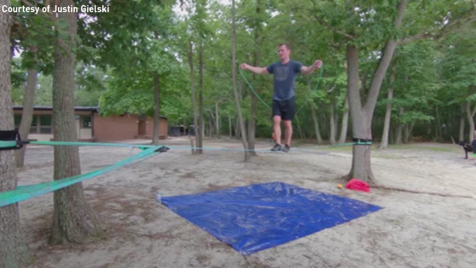Justin Gielski sets a Guinness World Record of jumping rope on a slack line 27 consecutive times.