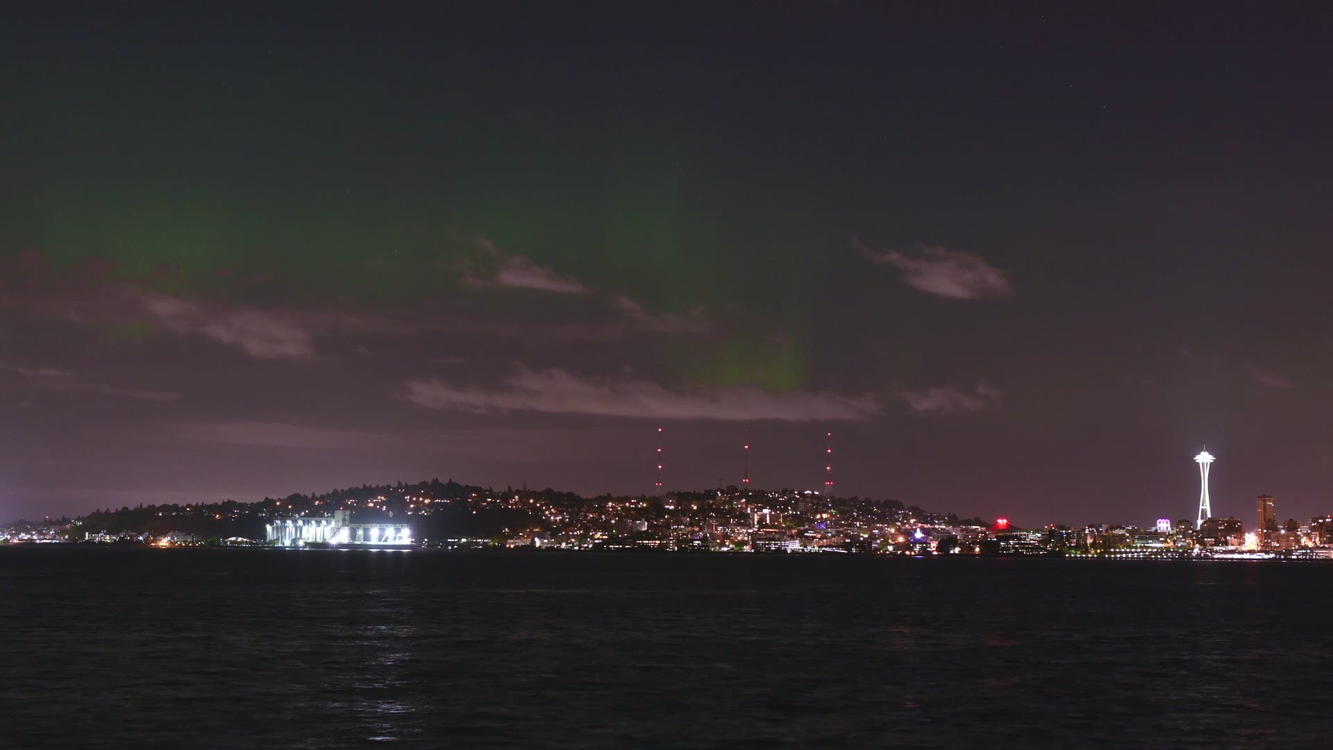 Awesome Aurora Northern Lights dance above Seattle skyline