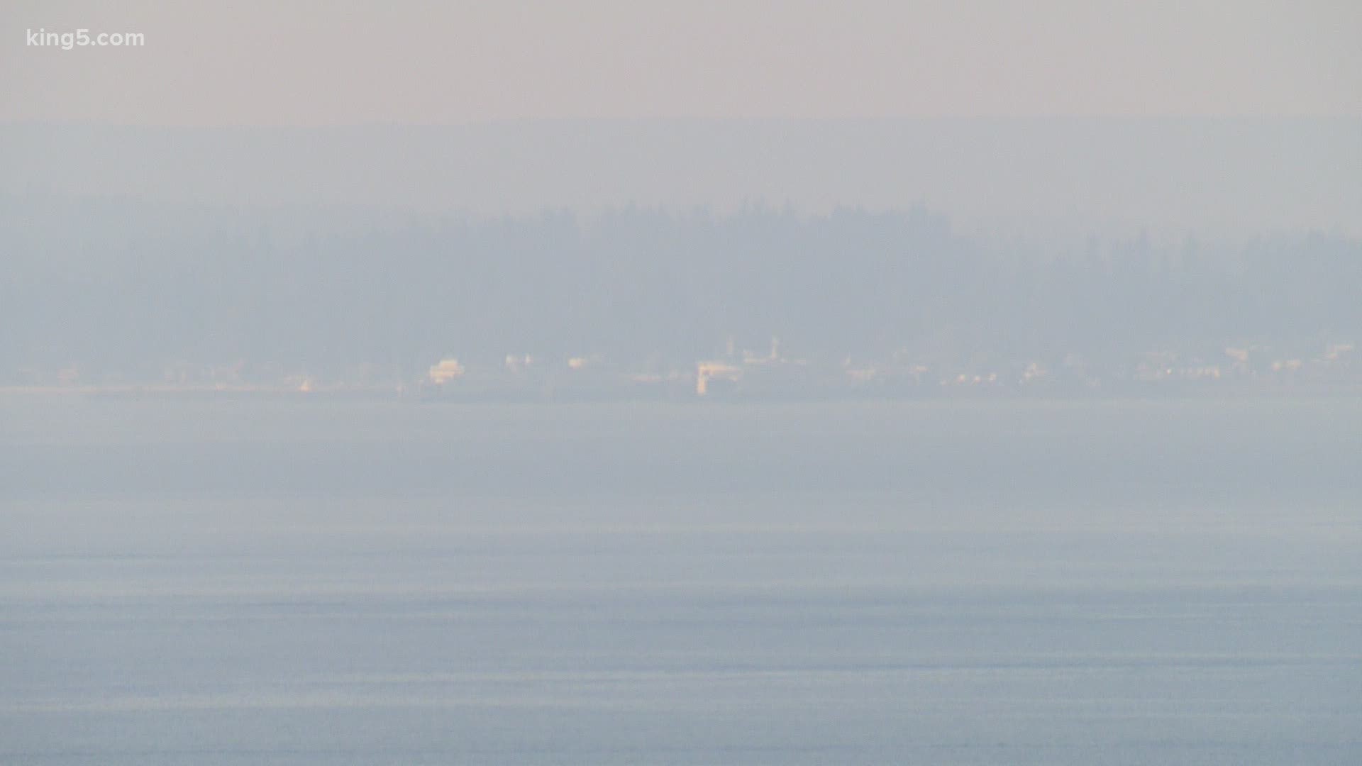 Haze, smoke and ash from the eastern Washington wildfires have lowered air quality in Puget Sound. People are advised to stay indoors and shut their windows.