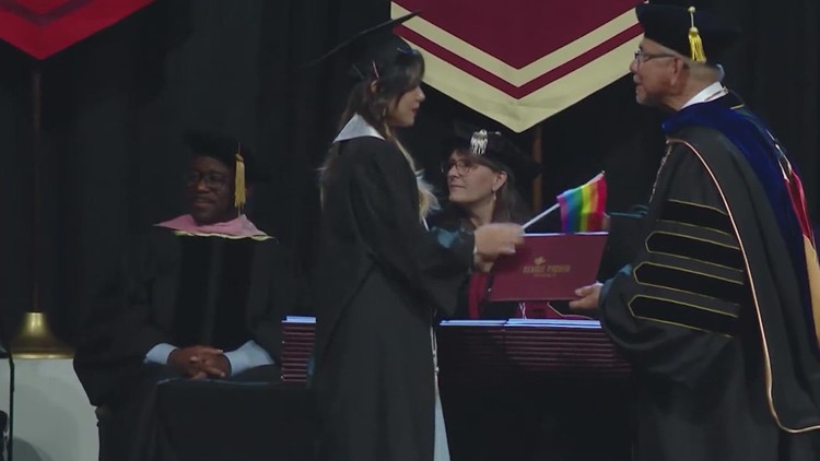 Seattle Pacific University students hand president pride flags instead of shaking his hand at graduation