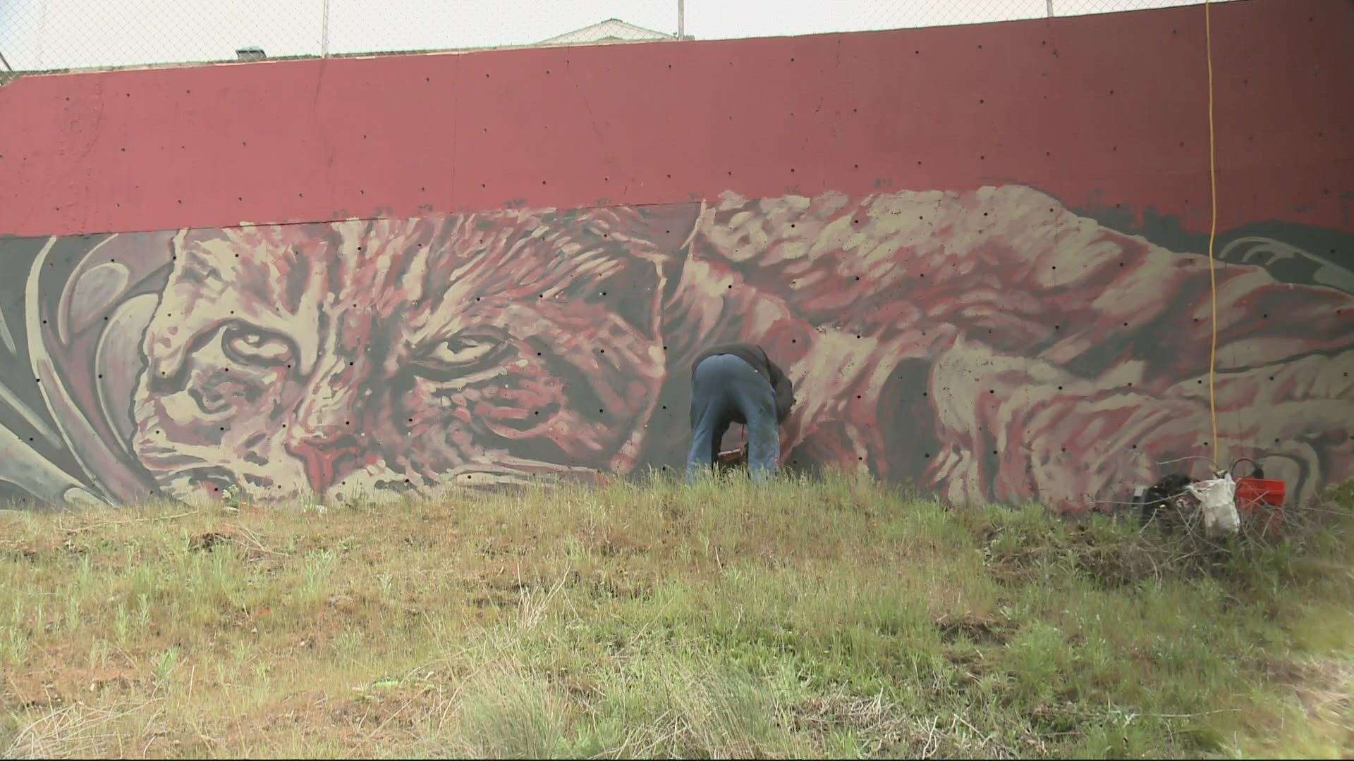 Two local artists are doing their part in providing a little motivation for Bloomsday runners working their way up the course's infamous hill