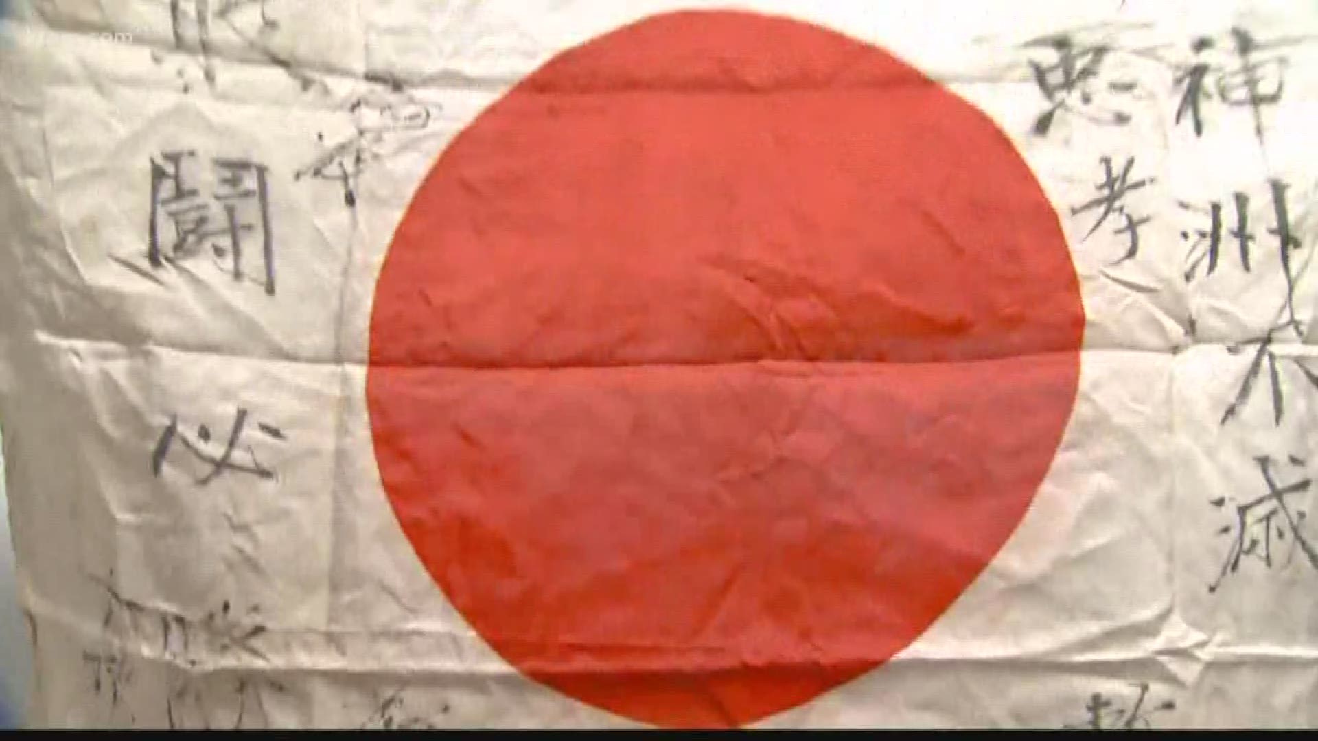 The five old flags are adorned with Japanese handwriting, likely messages from family members to their sons who left for combat.