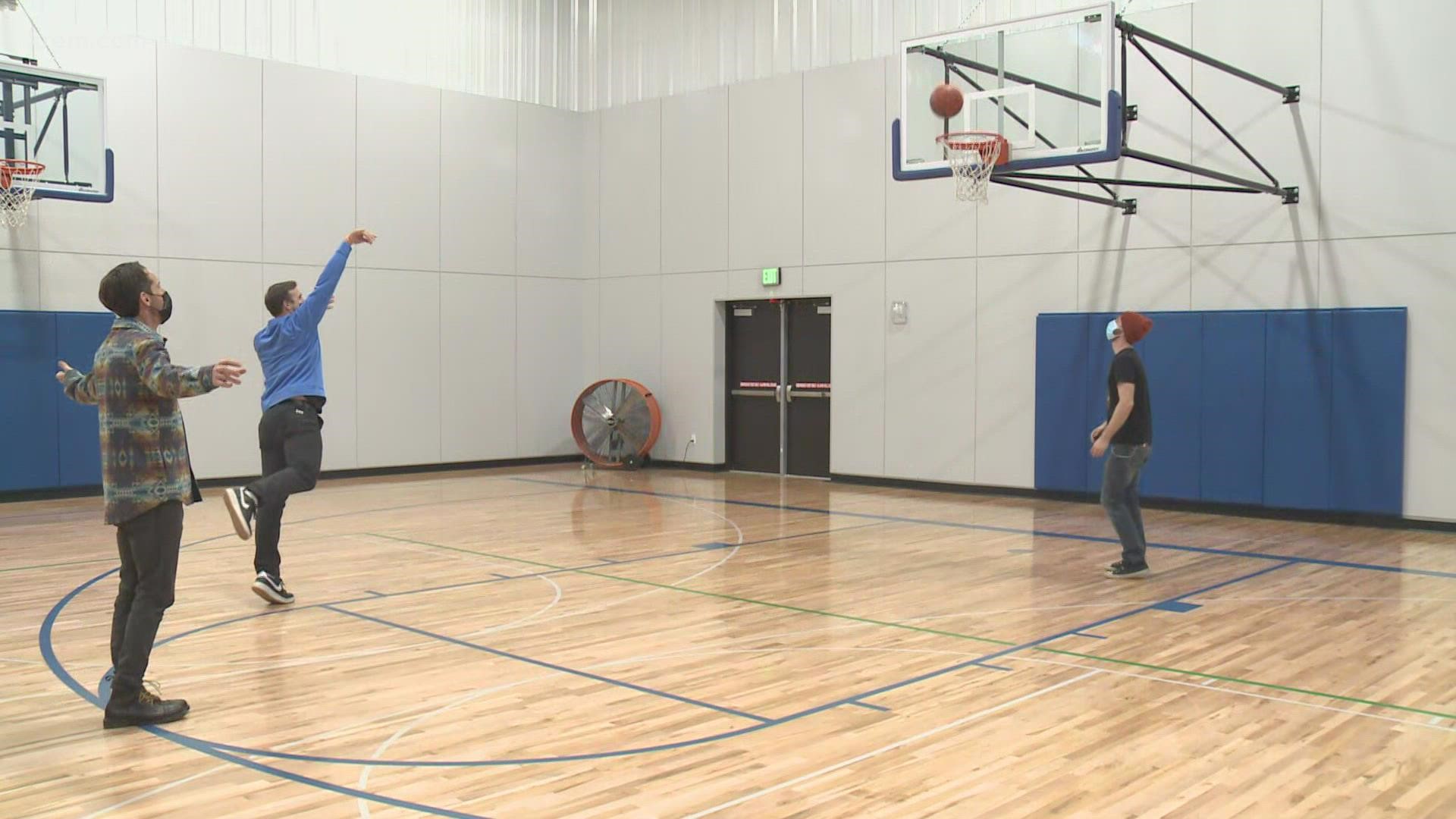 KREM 2's Jeremy LaGoo shoots some "horse" with Andy Gardner while discussing what makes the neighborhood's recreation center so loved in Airway Heights.