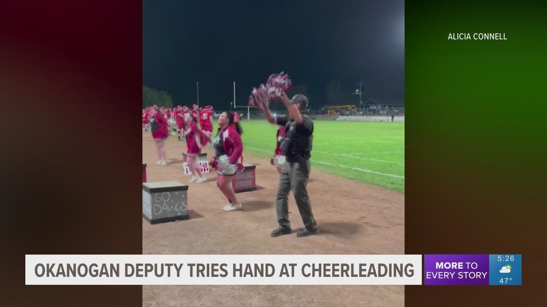 Deputy Tony Marchand grabbed the pom poms and hopped on the field Friday night to cheer with his daughter and the Okanogan High School cheerleaders.