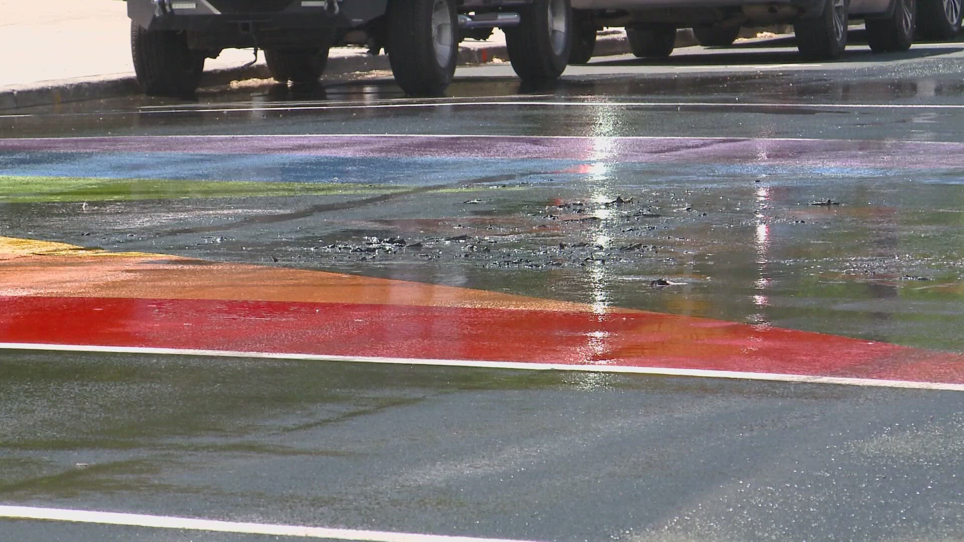 Police say video surveillance shows multiple people dumping liquid on the Pride mural in front of Riverfront Park before setting it on fire.