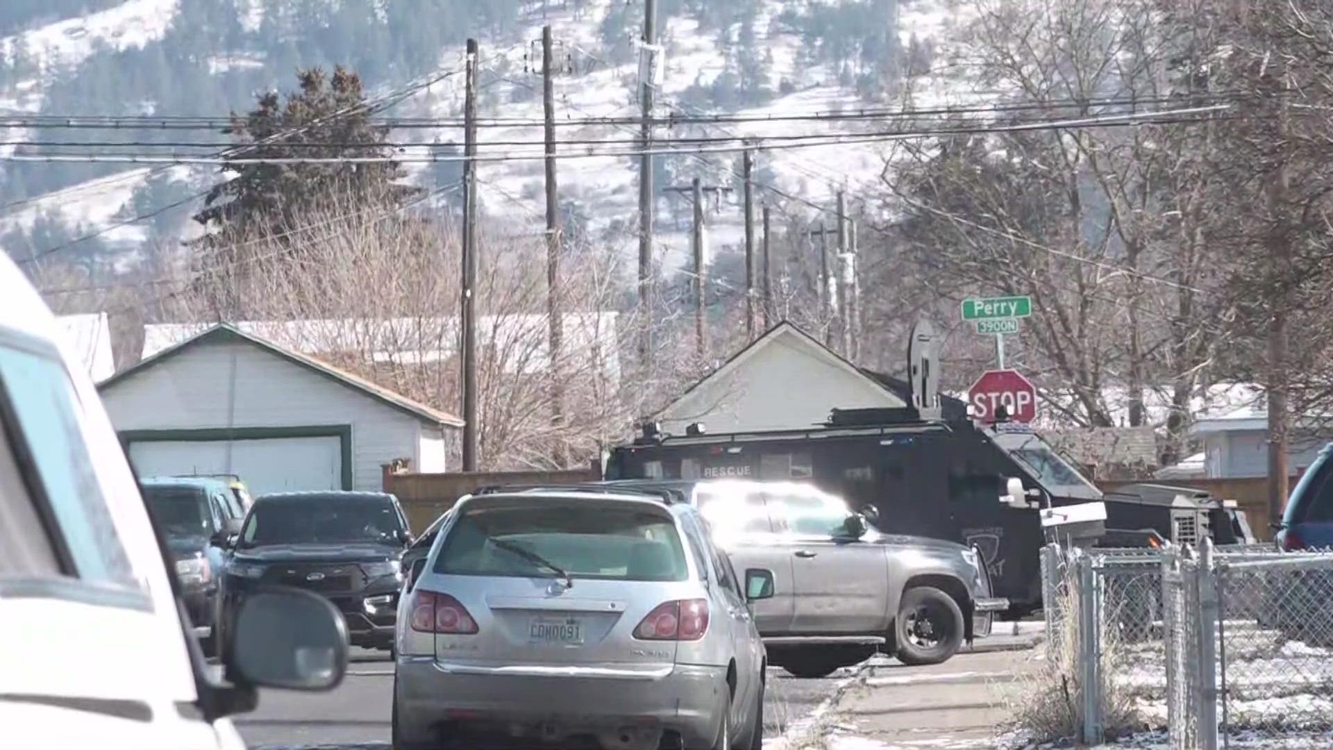 Police are surrounding a house at the corner of East Garland Avenue and North Perry Street.