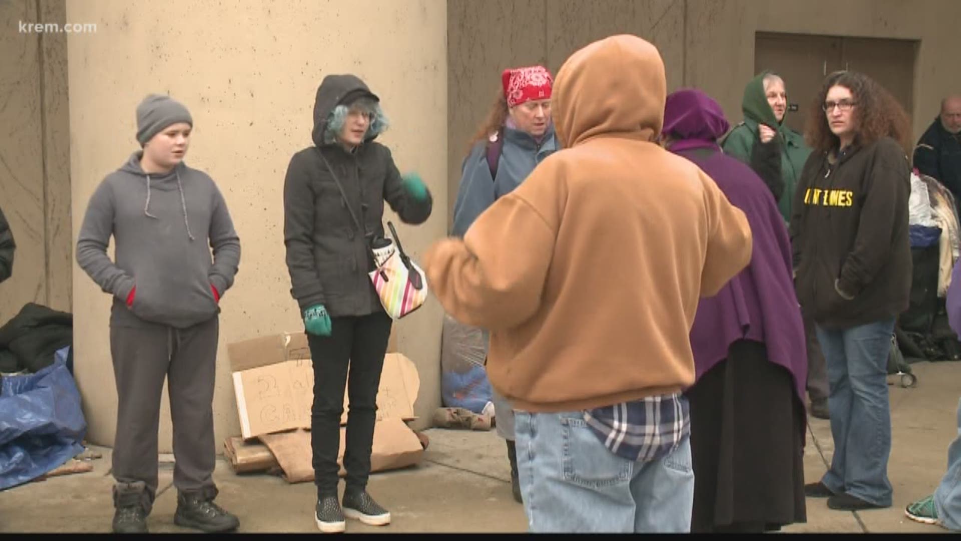 Demonstrators formed a wall around homeless residents' belongings at Spokane City Hall on Monday morning. The demonstrators say police planned to remove the belongings.