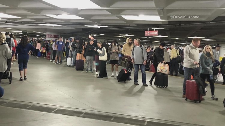 Seattle airport experience forces long line of travelers into parking garage