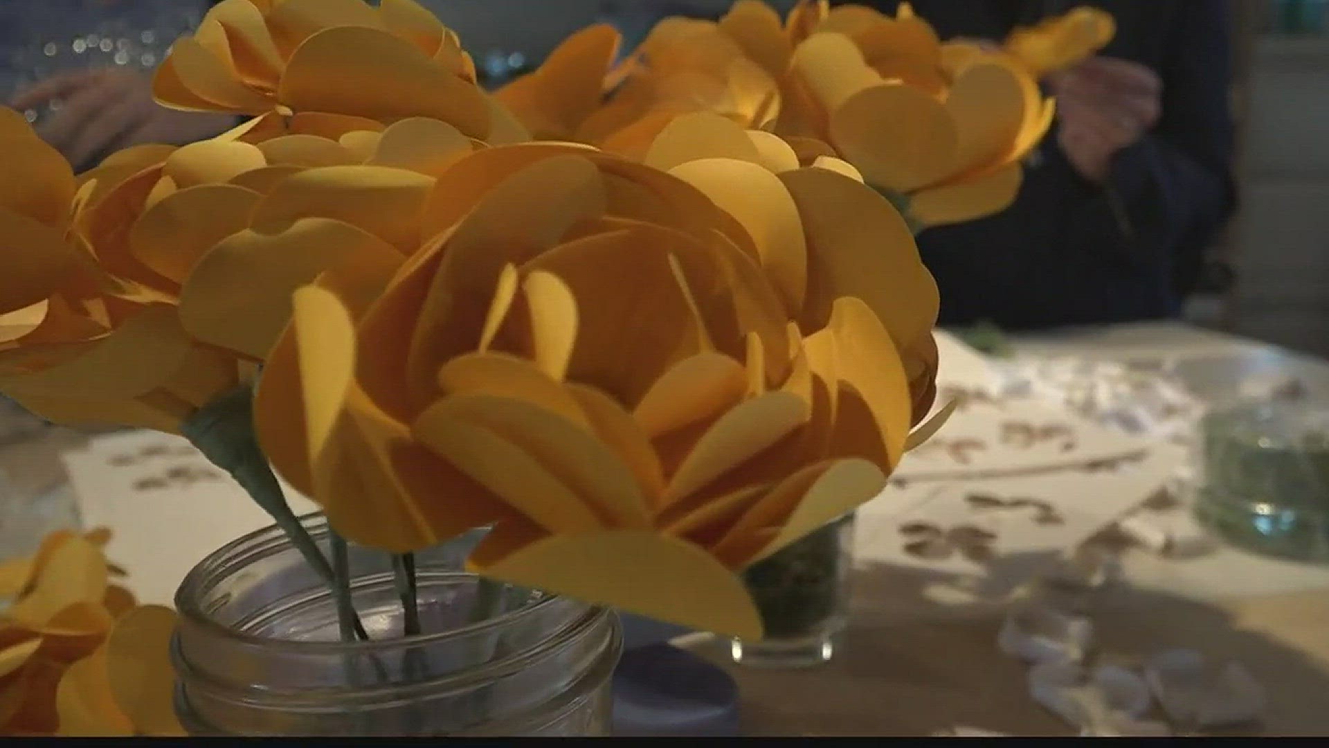 Volunteers help make flowers for Sam Strahan's memorial service (9-21-17)