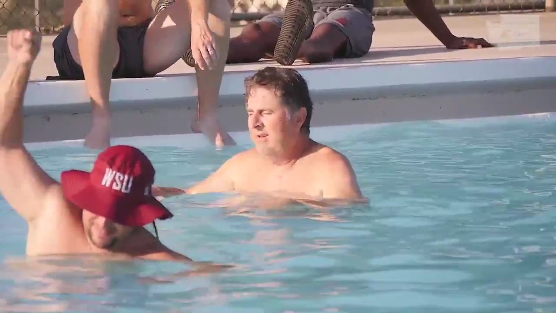 The WSU football team pressured Coach Mike Leach into belly flopping into a Lewiston pool.