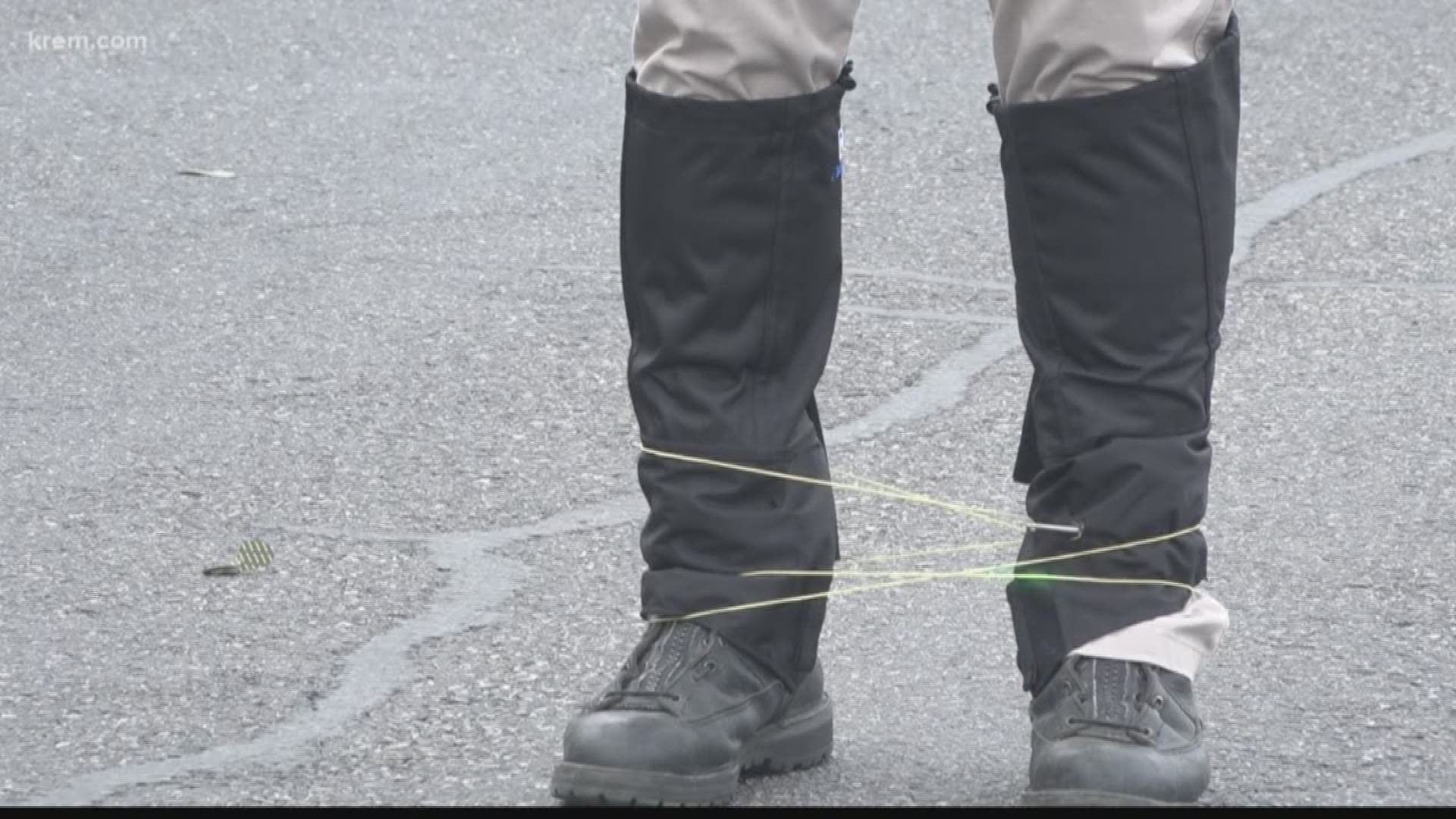 The device launches a 7-foot cord with an anchor on each end. The cord wraps around a person’s body and attaches to their clothes, making it difficult to move.