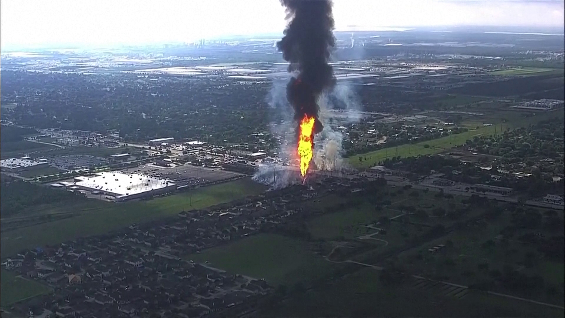 Firefighters are battling a massive pipeline fire in suburban Houston that sparked grass fires and damaged a nearby park.