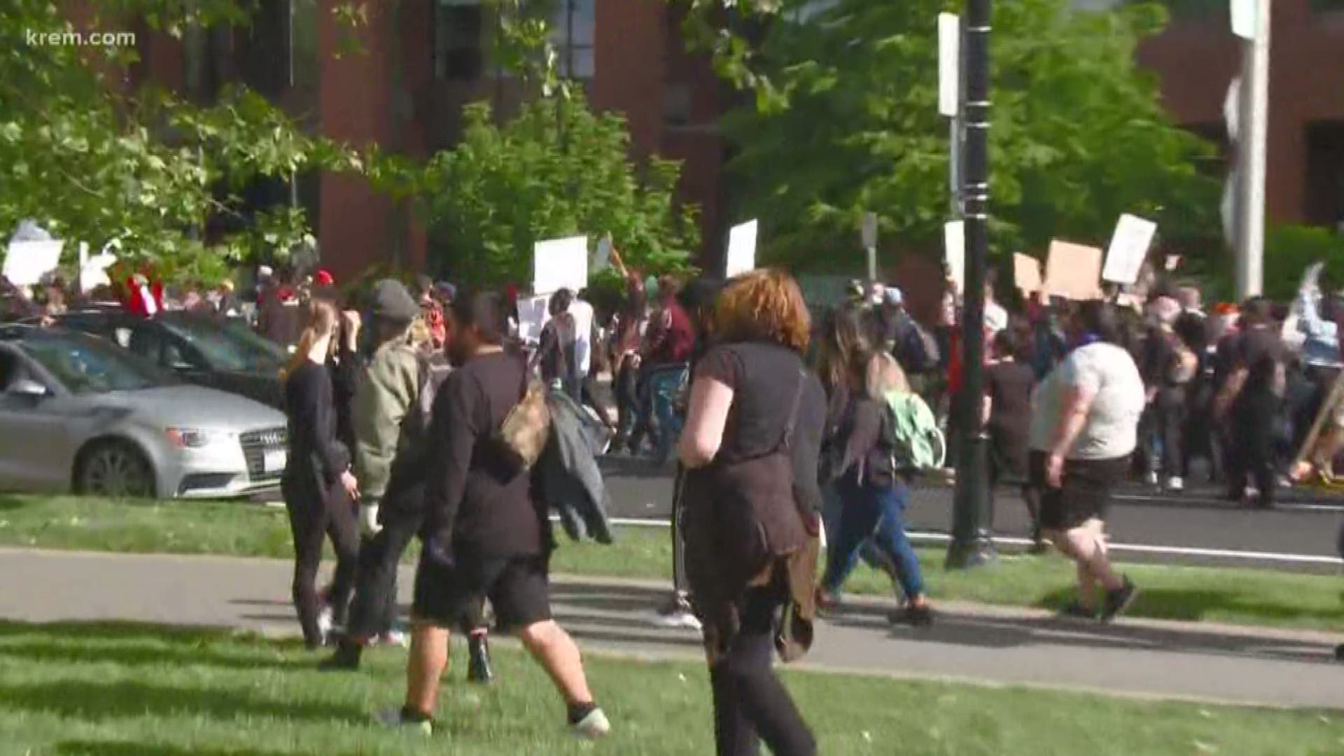 A crowd of protesters continues to march down streets in downtown Spokane.